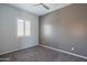 Bedroom featuring neutral gray walls, window with shutter, ceiling fan, and carpeted floor at 18925 W Windsor Blvd, Litchfield Park, AZ 85340