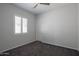 Cozy bedroom featuring neutral paint, plush carpet, and a window with crisp white shutters at 18925 W Windsor Blvd, Litchfield Park, AZ 85340