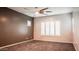 Cozy bedroom with neutral walls, carpet flooring, a ceiling fan, and window with plantation shutters at 18925 W Windsor Blvd, Litchfield Park, AZ 85340