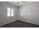 Bedroom with neutral walls, carpeted floor, white trim, ceiling fan, and window with shutter at 18925 W Windsor Blvd, Litchfield Park, AZ 85340