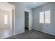 Bright bedroom features carpet and two windows with plantation shutters at 18925 W Windsor Blvd, Litchfield Park, AZ 85340