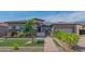 Charming single-story home featuring a well-maintained lawn, brick walkway, and desert landscaping at 18925 W Windsor Blvd, Litchfield Park, AZ 85340