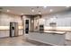 Stylish kitchen featuring white cabinets, a center island, stainless steel appliances, and sleek countertops at 18925 W Windsor Blvd, Litchfield Park, AZ 85340