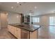 Spacious kitchen island offers seating and stainless dishwasher with view to living space and outdoor pool at 18925 W Windsor Blvd, Litchfield Park, AZ 85340