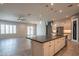 Modern kitchen with a large island, stainless steel appliances, and stylish pendant lighting at 18925 W Windsor Blvd, Litchfield Park, AZ 85340