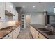 Modern kitchen featuring a large island, white cabinets, and stainless steel appliances at 18925 W Windsor Blvd, Litchfield Park, AZ 85340