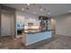 Modern kitchen featuring white cabinetry, stainless steel appliances, and a large island with pendant lighting at 18925 W Windsor Blvd, Litchfield Park, AZ 85340