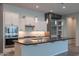 Well-appointed kitchen with a large island, stainless steel appliances, and white subway tile backsplash at 18925 W Windsor Blvd, Litchfield Park, AZ 85340