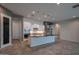This spacious kitchen features a central island, stainless appliances, and sleek, modern finishes at 18925 W Windsor Blvd, Litchfield Park, AZ 85340