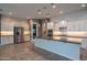 Modern kitchen with stainless steel appliances, a large island, pendant lighting, and a tile backsplash at 18925 W Windsor Blvd, Litchfield Park, AZ 85340