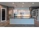 Open-concept kitchen with a large island, pendant lighting, and modern appliances at 18925 W Windsor Blvd, Litchfield Park, AZ 85340