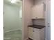Laundry room with white cabinets, countertop, gray tile floor, and washer/dryer hookups at 18925 W Windsor Blvd, Litchfield Park, AZ 85340