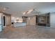 Open-concept living area with a modern kitchen, fireplace, and stylish lighting fixtures at 18925 W Windsor Blvd, Litchfield Park, AZ 85340