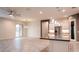 Open-concept living space with tile floors, modern lighting, and seamless flow to the kitchen area at 18925 W Windsor Blvd, Litchfield Park, AZ 85340