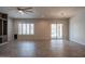 Bright living room featuring a sliding glass door to the pool area and plantation shutters at 18925 W Windsor Blvd, Litchfield Park, AZ 85340