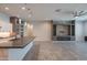 Open-concept living space showcasing a sleek fireplace, tile flooring, and modern lighting fixtures at 18925 W Windsor Blvd, Litchfield Park, AZ 85340