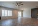 Light-filled living room with sliding glass doors, plantation shutters, and tile floors creates inviting atmosphere at 18925 W Windsor Blvd, Litchfield Park, AZ 85340
