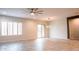 Spacious living area featuring tile floors, a modern ceiling fan, and sliding glass doors leading to the backyard at 18925 W Windsor Blvd, Litchfield Park, AZ 85340