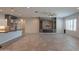Open concept living room with fireplace, and a view into the kitchen and dining areas at 18925 W Windsor Blvd, Litchfield Park, AZ 85340