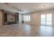 Spacious living room features stone entertainment center, modern fireplace, and sliding glass door to the pool at 18925 W Windsor Blvd, Litchfield Park, AZ 85340