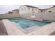 Clean rectangular pool with patio and green accents in a desert landscape provides backyard escape at 18925 W Windsor Blvd, Litchfield Park, AZ 85340