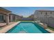 Backyard pool with tiled patio and artificial turf at 18925 W Windsor Blvd, Litchfield Park, AZ 85340