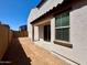 A backyard with a small patio and view of the home's exterior with a window at 1909 W Lariat Ln, Phoenix, AZ 85085