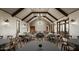 Bright banquet hall featuring exposed beams, a modern chandelier, and tables for celebratory events at 1909 W Lariat Ln, Phoenix, AZ 85085