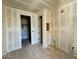 Unfinished bathroom featuring tiled walls, two doors, and exposed plumbing at 1909 W Lariat Ln, Phoenix, AZ 85085