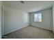 Cozy bedroom with soft, neutral carpet, white walls, and a window offering natural light at 1909 W Lariat Ln, Phoenix, AZ 85085