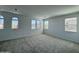 A bright bedroom showcasing carpeted floors and multiple windows offering neighborhood views at 1909 W Lariat Ln, Phoenix, AZ 85085