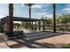 Relaxing outdoor space with picnic benches, shaded pergola, and greenery at 1909 W Lariat Ln, Phoenix, AZ 85085