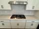 Close up on white cabinets with stainless steel appliances and a white backsplash over quartz counters at 1909 W Lariat Ln, Phoenix, AZ 85085