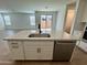 Modern kitchen island with quartz countertop, stainless steel dishwasher, and a stainless steel sink at 1909 W Lariat Ln, Phoenix, AZ 85085