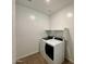 Well-lit laundry room features new washer and dryer with tile floors at 1909 W Lariat Ln, Phoenix, AZ 85085