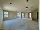 Spacious living room with multiple windows and sliding door with unfinished walls at 1909 W Lariat Ln, Phoenix, AZ 85085