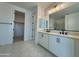 An elegant main bathroom with dual sinks, modern fixtures, and tiled floors at 1909 W Lariat Ln, Phoenix, AZ 85085