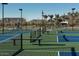 Modern pickleball courts in a community, featuring green and blue surfaces, benches, and fenced perimeters at 1909 W Lariat Ln, Phoenix, AZ 85085