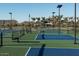 Modern pickleball courts in a community, featuring green and blue surfaces, benches, and fenced perimeters at 1909 W Lariat Ln, Phoenix, AZ 85085