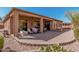 Large covered patio with brick pavers, outdoor dining area, and outdoor kitchen at 1926 W Wayne Ln, Anthem, AZ 85086