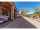 Long view of covered patio featuring brick pavers and outdoor kitchen area at 1926 W Wayne Ln, Anthem, AZ 85086