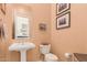 Charming powder room with pedestal sink and framed artwork, perfect for guests at 1926 W Wayne Ln, Anthem, AZ 85086