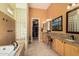 Luxurious bathroom featuring dual sinks, granite counters, and separate tub and shower at 1926 W Wayne Ln, Anthem, AZ 85086