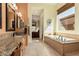 Bright bathroom with tub, large window and granite countertops at 1926 W Wayne Ln, Anthem, AZ 85086