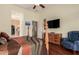 Comfortable bedroom featuring a wooden four poster bed, a blue upholstered armchair and a TV at 1926 W Wayne Ln, Anthem, AZ 85086