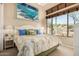 Inviting bedroom features a white bed frame, a patterned bedspread, and lots of natural light at 1926 W Wayne Ln, Anthem, AZ 85086