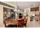 Dining room with glass top table near an open kitchen and sliding glass doors at 1926 W Wayne Ln, Anthem, AZ 85086