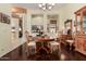 Cozy dining room with a wooden table set, decorative mirror, and view into an adjacent room at 1926 W Wayne Ln, Anthem, AZ 85086