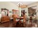 Elegant dining room with a wooden table, chandelier, and hardwood floors, perfect for gatherings at 1926 W Wayne Ln, Anthem, AZ 85086