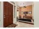 Inviting entryway with tile flooring, a wood door, and a view into a living space with a piano at 1926 W Wayne Ln, Anthem, AZ 85086